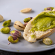 Pistachio spread on piece of bread on plate